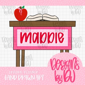 May include: A digital illustration of a wooden desk with a pink front panel featuring the name "mabpie" in red script. An open book and a red apple with a pink ribbon sit on the desk surface. The background is a white grid with pink polka dots.