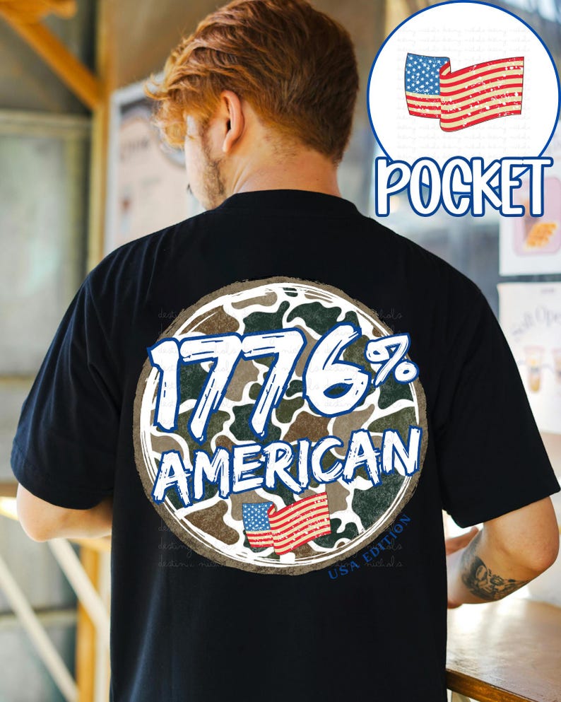 K&ouml;nnte beinhalten: Schwarzes T-Shirt mit einem kreisf&ouml;rmigen Aufdruck auf dem R&uuml;cken. Der Aufdruck zeigt den Text "1776% AMERICAN" in Wei&szlig; und Blau, vor einem Tarnmuster. Enth&auml;lt eine kleine amerikanische Flagge. Das Shirt hat auch einen "USA Edition" Text.