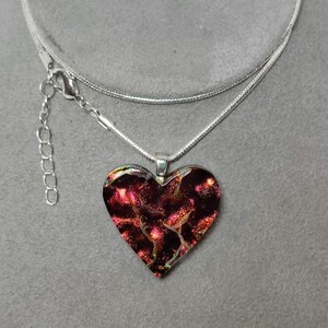 Fused red dichroic glass heart pendant on black with silver chain