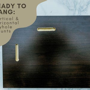 a dark wooden surface with a keyhole, accompanied by text that reads "READY TO HANG: Vertical & Horizontal Keyhole Mounts".