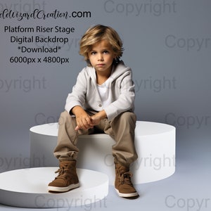 May include: A young boy wearing a white sweater and khaki pants sits on a white platform riser stage. The background is a light gray. The text "Steelelvizard Creation.com" is at the top of the image. The text "Platform Riser Stage Digital Backdrop *Download* 6000px x 4800px" is below the website address.