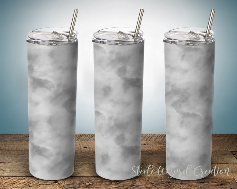May include: Three stainless steel tumblers with lids and straws. The tumblers are white with a gray marble pattern.