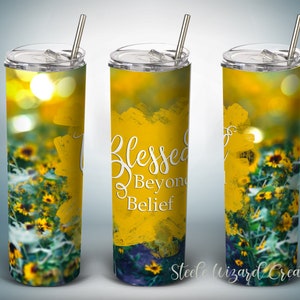 May include: A yellow stainless steel tumbler with a floral design and the text "Blessed Beyond Belief".