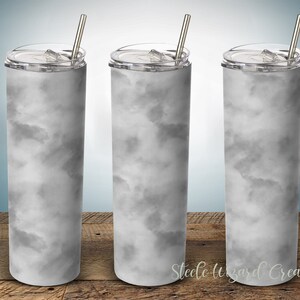 May include: Three stainless steel tumblers with lids and straws. The tumblers are white with a gray marble pattern.