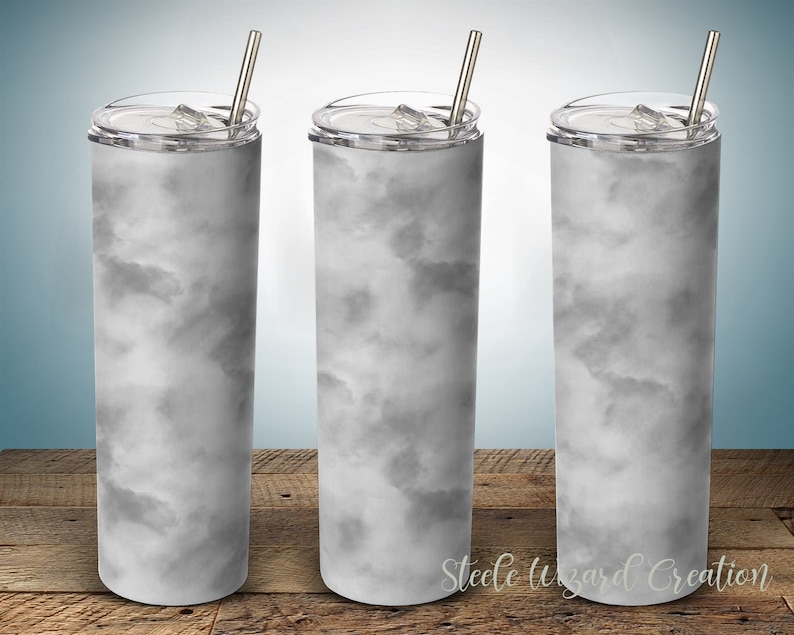 May include: Three stainless steel tumblers with lids and straws. The tumblers are white with a gray marble pattern.
