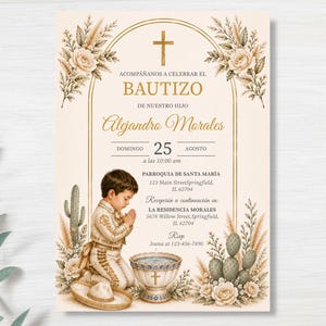 May include: A baptism invitation card featuring a gold arch, a cross, and floral arrangements with pampas grass and cacti. It depicts a young child in traditional attire kneeling in prayer beside a baptismal font, with text details included.