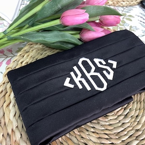 May include: Black satin bow tie with white embroidered monogram "KRS".
