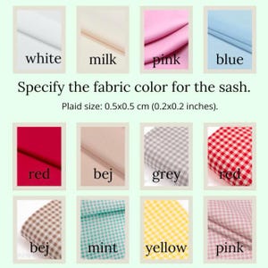 May include: A color chart for fabric sashes, featuring swatches of white, milk, pink, and blue solid colors, along with plaid patterns in red, grey, mint, and yellow. The text specifies the fabric color and plaid size of 0.2 x 0.2 inches.