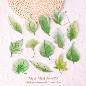 May include: A set of twenty embroidered leaf patches in various shades of green, featuring diverse botanical shapes including pointed, rounded, and lobed designs. One leaf shows a measurement of 8.13 cm. The text reads Mix & Match Set of 20 Back for Iron-On / Sew-On.