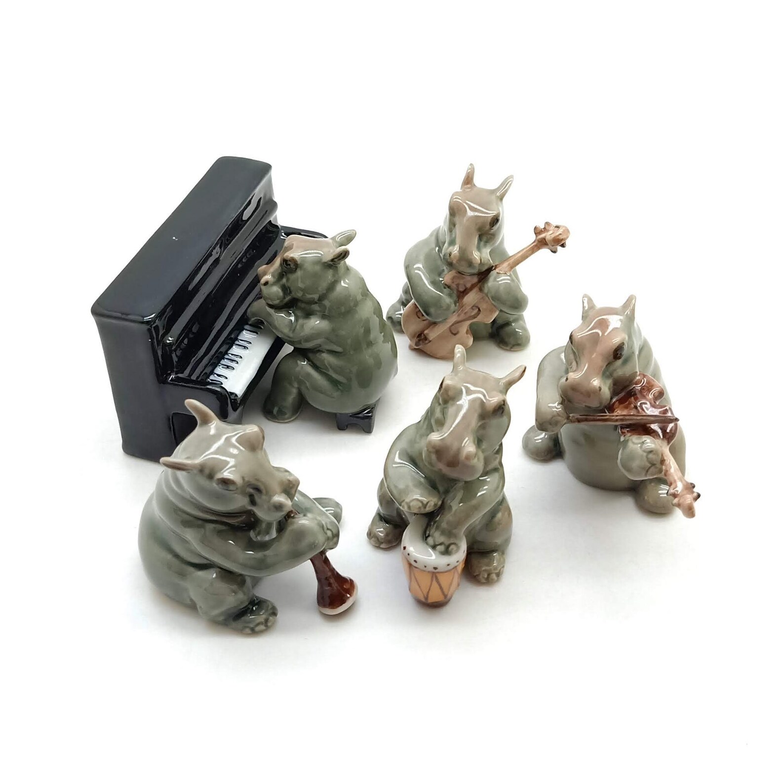 ceramic figurines of hippo's playing music.  piano, guitar, violin, etc
