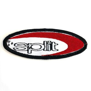 May include: A white oval embroidered patch with a red crescent moon and the word "split" in black lettering.