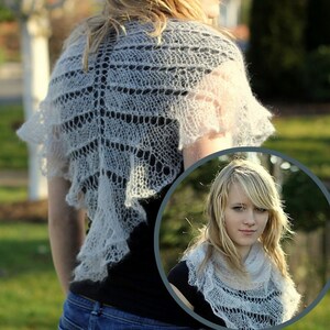 May include: A white lace shawl with a delicate pattern. The shawl is draped over the shoulders of a person wearing a black shirt and blue jeans.