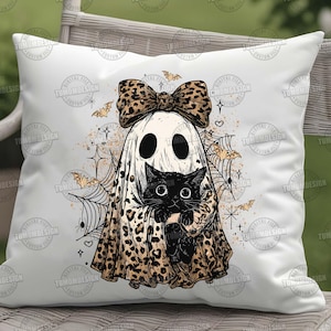 May include: White square pillow featuring a Halloween-themed design. A ghost with a leopard print bow and cape is holding a black cat. The design includes bats, spiderwebs, and stars. The pillow is a decorative item.