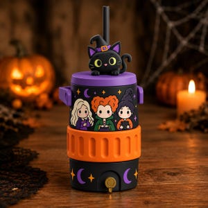 May include: A cylindrical beverage cooler featuring a black base with purple crescent moons and orange stars, a bright orange middle band, and a black top section decorated with three cartoon characters and a black cat wearing a purple witch hat.