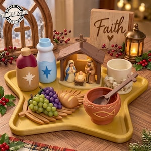 May include: A star-shaped yellow tray holds a nativity scene with figurines of Mary, Joseph, and baby Jesus in a wooden stable. Included are two bottles with star icons, a bowl with a fish symbol and spoon, a loaf of bread, grapes, and a sheep-themed cup.