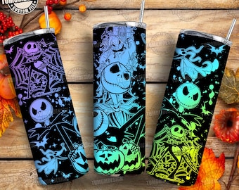 May include: Three black insulated tumblers with Halloween-themed designs. Each tumbler features a different design with Jack Skellington, spiderwebs, and bats in shades of blue, purple, and green. The tumblers have silver lids and straws.