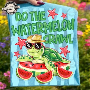 May include: Light blue t-shirt with a cartoon turtle wearing sunglasses and a straw hat, resting on watermelon slices. The shirt features the text "DO THE WATERMELON CRAWL" in green letters, with red star accents. A fun, summer-themed design.