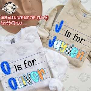 May include: Two long-sleeved sweatshirts, one white and one beige, with personalized text. The white sweatshirt says "O is for Oliver" in blue, orange, and black. The beige sweatshirt says "J is for Jayden" in blue, yellow, and black.