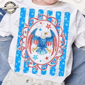 May include: White t-shirt featuring a patriotic design with a blue and red eagle illustration. The eagle is centered within a red and white floral oval, surrounded by blue stars and stripes. The shirt has a digital file design.