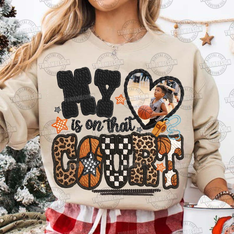 May include: Beige sweatshirt featuring the text "MY is on that COURT" in black, leopard print, and basketball-themed designs. A heart-shaped photo of a child playing basketball is in the center.