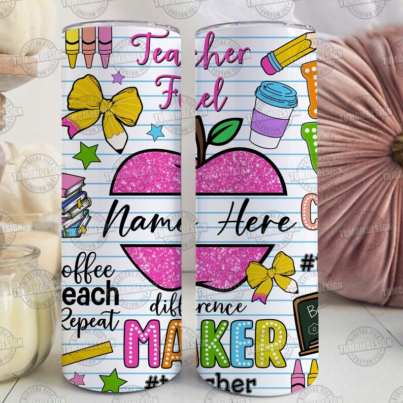 May include: A white tumbler with a school-themed design. It features a pink apple with the text "Name Here", along with colorful illustrations of pencils, crayons, and the words "Teacher Fuel" and "Difference Maker".