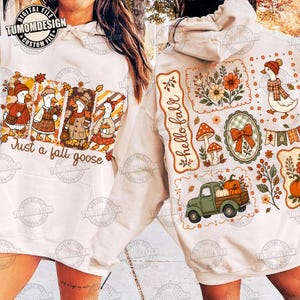 May include: A cream-colored hooded sweatshirt featuring a graphic print of four geese dressed in autumn clothing with the text Just a fall goose on the front and a collection of fall-themed illustrations including a truck and the text hello fall.