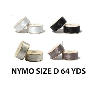 May include: Spools of NYMO Size D thread in white, black, silver, and gray. Each spool is displayed with a matching spool next to it. The text "NYMO SIZE D 64 YDS" is printed in black.