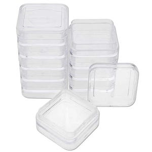 May include: A stack of clear plastic square storage containers. The containers are stacked in a tower with the top container open. There are also three individual containers on the table.