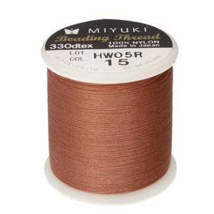 May include: A spool of MIYUKI Beading Thread in a warm brown color. The label indicates it is 100% nylon, 330dtex, and made in Japan. The spool is labeled with the code HWO5R and color 15.