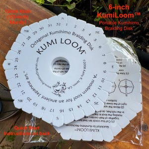 May include: A white 6-inch KumiLoom octagonal braiding disk for Kumihimo, 1/2-inch thick and sturdy. The disk features numbered notches from 1 to 32, cardinal directions, a frog illustration, and text including "A modern tool for an ancient Japanese art."