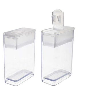 May include: Two clear plastic containers with lids. The container on the right has a hinged lid with a small handle.