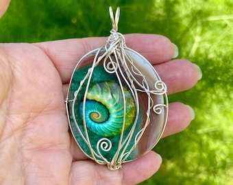 Earthy Agate with Glass Snail Design wire wrapped pendant. Translucent. Cord included.