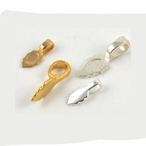 May include: Four gold and silver pendant bails, two of each color. The bails are shaped like a teardrop with a loop at the top. They are used for attaching pendants to necklaces or bracelets.