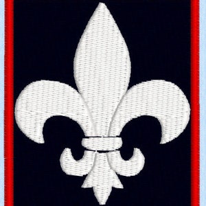 May include: A white embroidered fleur-de-lis on a dark blue background with a red and light blue border.