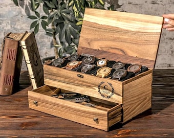 May include: A wooden watch box with a hinged lid and a pull-out drawer. The box features a natural wood grain finish and a circular engraving with the letter C and the text CHARLES EST 1988. Inside, the box holds ten wristwatches on black cushions.