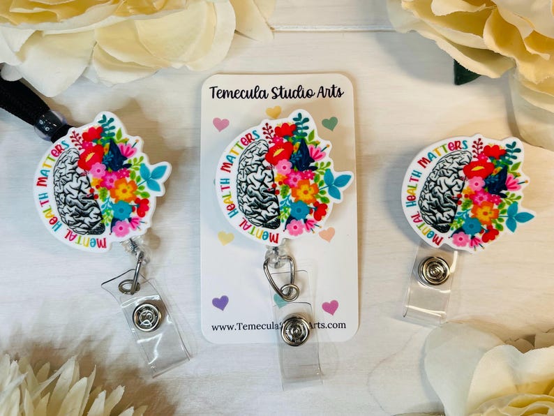 May include: Three white badge reels with a colorful brain design and the text "Mental Health Matters".