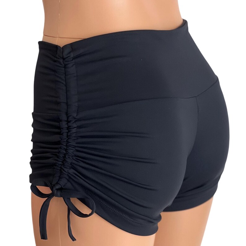 May include: Black athletic shorts with a gathered detail on the back and a drawstring on the side.