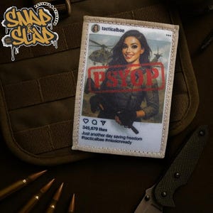 May include: A rectangular patch with an Instagram-style image of a woman and a helicopter, stamped with "PSYOP." The patch includes text: "Just another day saving freedom" and "#tacticalbae #missionready."