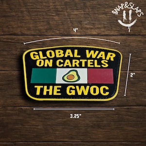 May include: A black patch with yellow trim, measuring 4 inches wide and 2 inches tall. The patch features the text "GLOBAL WAR ON CARTELS" and "THE GWOC" in yellow. It includes a design of the Mexican flag with an avocado in the center.