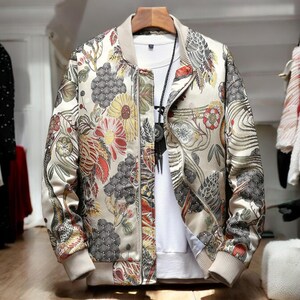 May include: A beige bomber jacket with a floral print featuring a variety of colors, including red, yellow, and green. The jacket has a zipper closure and a ribbed collar.