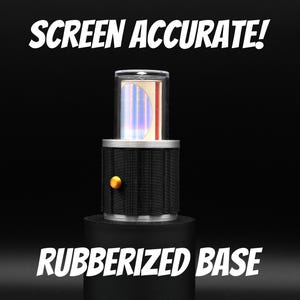 May include: A cylindrical prop with a black rubberized base, a black ribbed middle section featuring a small gold-colored circular button, and a clear top housing a reflective iridescent insert. The text SCREEN ACCURATE! and RUBBERIZED BASE appear.