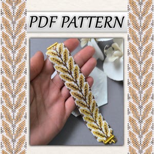 May include: A beaded bracelet with a leaf pattern in white, gold, and brown. The bracelet has a gold clasp. The image also includes the text "PDF PATTERN".