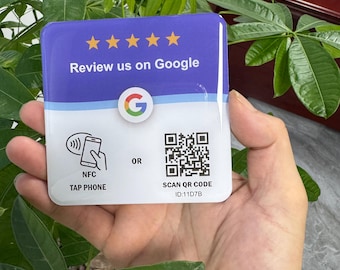May include: A square sign with a glossy finish featuring a purple top section with five yellow stars and the text Review us on Google. The white bottom section displays a Google logo, an NFC tap phone icon, a QR code, and the text ID:11D7B.