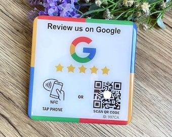 May include: A colorful sign with the Google logo and the text "Review us on Google". The sign has a QR code and instructions to scan it or tap a phone to leave a review. The ID for the QR code is 997CA.