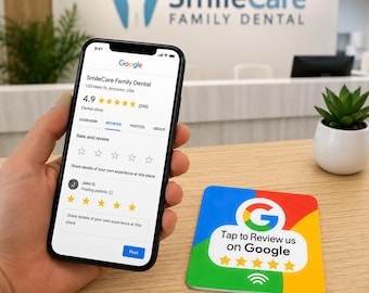 May include: A black smartphone displaying a Google review page for SmileCare Family Dental with a 4.9 star rating. Beside it sits a square sign featuring the Google logo, five yellow stars, and the text Tap to Review us on Google with an icon.