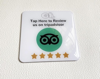 May include: White square sticker with a green TripAdvisor logo, five gold stars, and the text "Tap Here to Review us on tripadvisor".