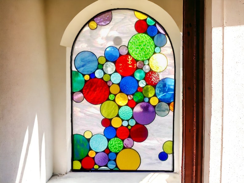 May include: A stained glass window with a colorful design of overlapping circles in shades of red, blue, green, yellow, and purple.