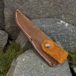 Leather knife sheath made from Crazy Horse leather, universal knife case for carving and outdoor knives on stone background
