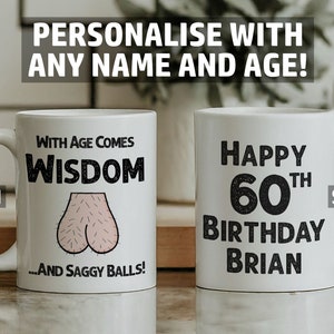 May include: White ceramic mug with a humorous birthday message. The front of the mug says "With age comes wisdom...and saggy balls!" The back of the mug says "Happy 60th Birthday Brian".