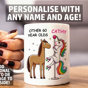 May include: White ceramic mug featuring a cartoon horse and unicorn. The mug has the text "OTHER 60 YEAR OLDS" and "CATHY" in pink. The mug also has the text "PERSONALISE WITH ANY NAME AND AGE!" and "ADD OPTIONAL PHOTO OR MESSAGE TO ONE SIDE!"